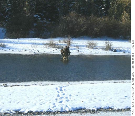 Hunters fording river