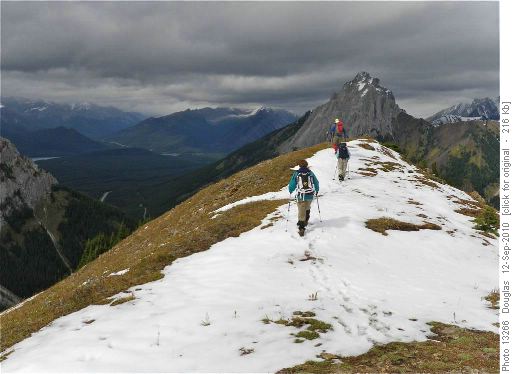 Sunny final summit with cloudy Smith-Dorrien in the distance