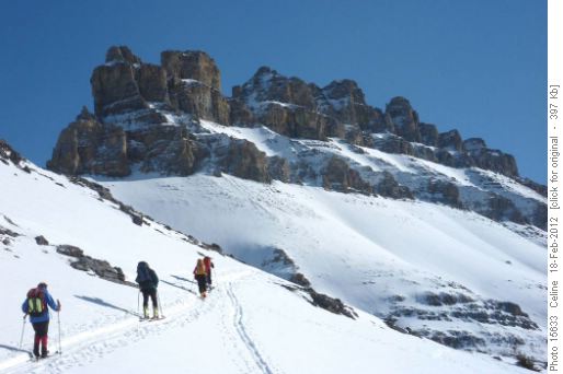 Ramblers climbing up the first pass with the Dolomites in the background