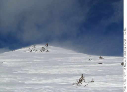 Sim climbing the windy summit bump