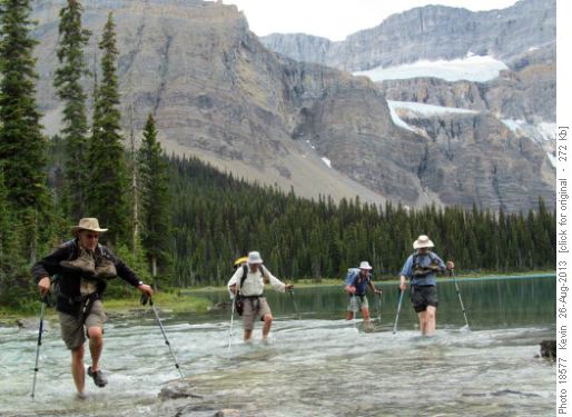 The boys wading back across the Bow River in the afternoon