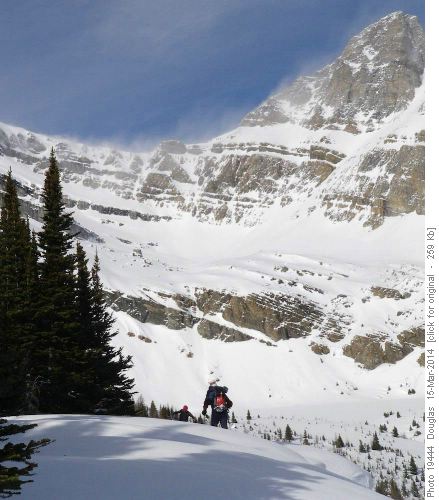 Manfred and Philip (in distance) at the top of the cornice run, with snow blowing off Richardson and Ptarmigan
