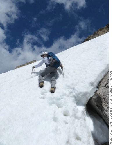 Sim ascending a short steep snow section below the false summit
