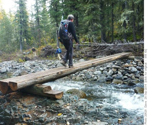 Pat crossing temporary bridge over Jumping Pound Creek