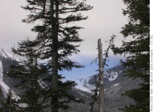 Blue reflections on mountain under low cloud