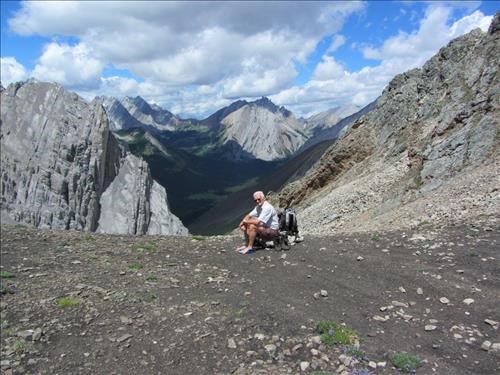 {826 John Katay} rests his weary feet while enjoying the view to the north of Piper Pass
