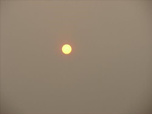 The sun burns through heavy smoke from forest fires