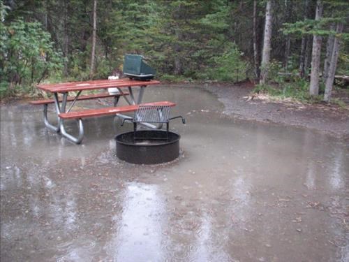 Flooded picnic table area in Two Medicine Lake Campground