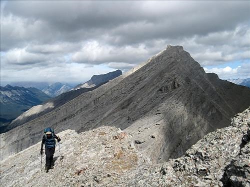 Jeannette approaching the summit of Emma's Peak. Mt. Lawrence Grassi in background