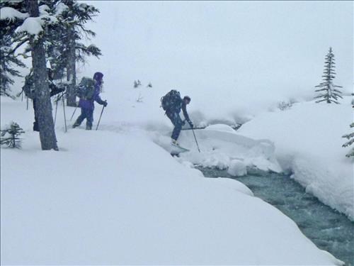 Ed crossing Hilda Creek on a tricky log/snow bridge