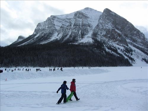 walkers and distant skaters on Lake Louise (Mt.Fairview behind)