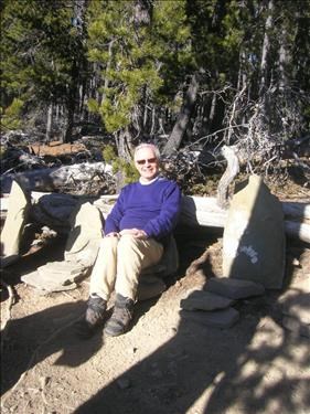 Carl enjoys sun-warmed stone seat at Baruch's Corner