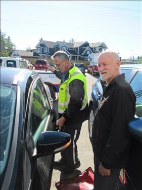 The AMA man opening Greg's locked car (keys inside) again