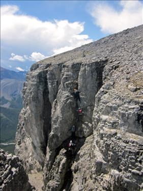 Ramblers ascending easier chimney on summit block of Mount Remus