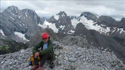Damian on the summit with the French and Robertson Glaciers in the background