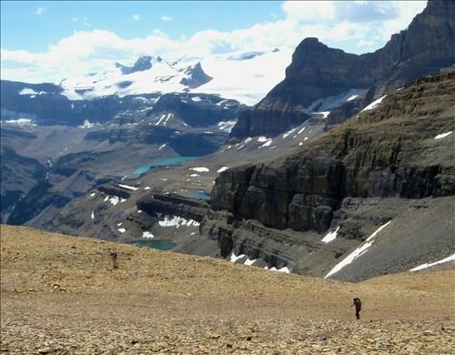 Yolande and Shirley walking up the broad ridge of Jimmy Simpson. Bow Glacier and Iceberg Lake in the distance.