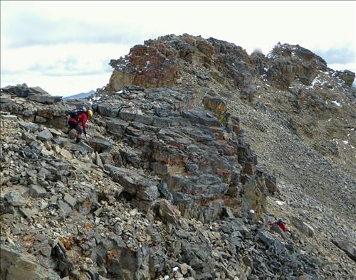 Sue picking her way down and around the rock outcrop.