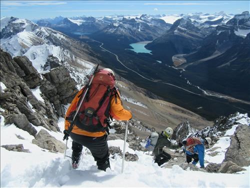 Descending the steep snowy section below the summit ridge