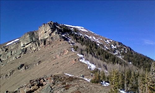 The trail goes right at the cliff band into the shade - often with snow and ice late season.