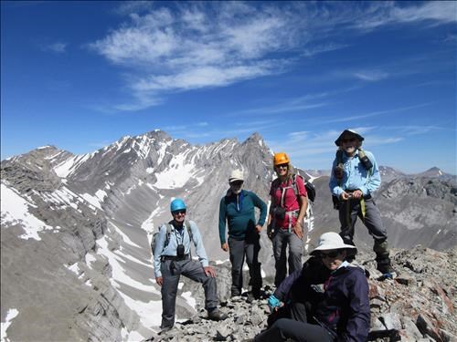 Ramblers on the Outlier summit with Mount Rae in the background