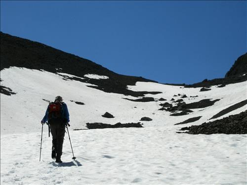 Doug D heading up the snow to the col