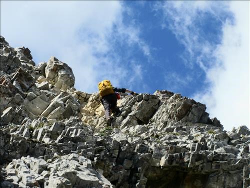 Damian scrambling on the East ridge of the North Peak of Indefatigable