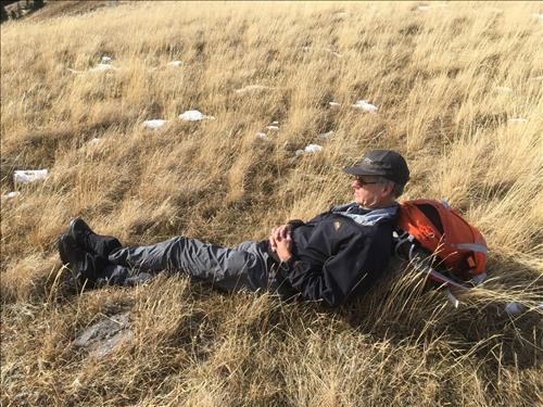 Evan enjoying the sun and view at Mist Ridge Col
