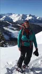 Carol on summit with Lake Louise ski area in background.