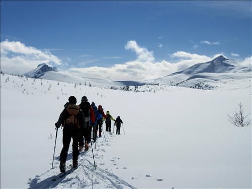 The gang traversing around Redoubt Lake with Unity Peak in the background