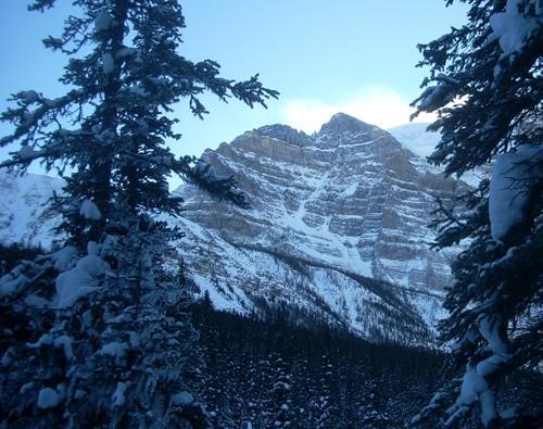 Sun hiding behind Mt. Temple