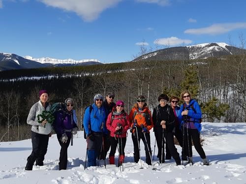 Group at lookout lunch spot, some with St. Patrick's Day decor