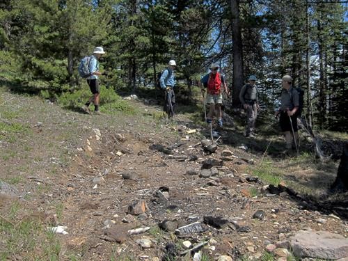 Ramblers pass the site of an old cabin on Bearmat Hill near Exshaw