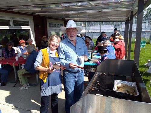 Social Director {206 Barb Mitchell} supervises {247 Bill Tajcnar} in the fine art of pancake flipping