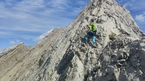 Ulli scrambling up exposed final ridge