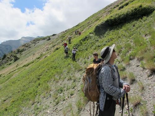 Jim scopes out the cliffs above while the rest pick their way along the animal trail