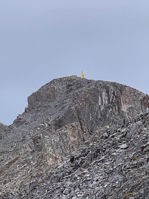 The man in yellow on one of the bumps of the south ridge