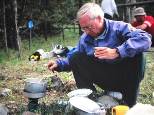 {225 carl potter} cooks dinner at a camp in the Fitzsimmons Creek valley