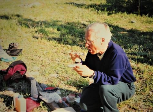 {225 carl potter} enjoys dinner at a camp in the Fitzsimmons Creek valley