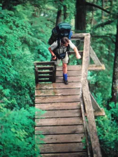 {220 ji pa} climbs a ladder on the West Coast Trail, BC