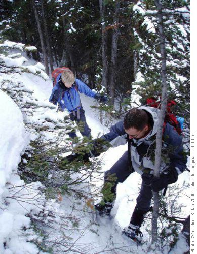 Jerome attempts a tricky snowshoe/scramble move while Jeannine stands by to pick up the pieces.