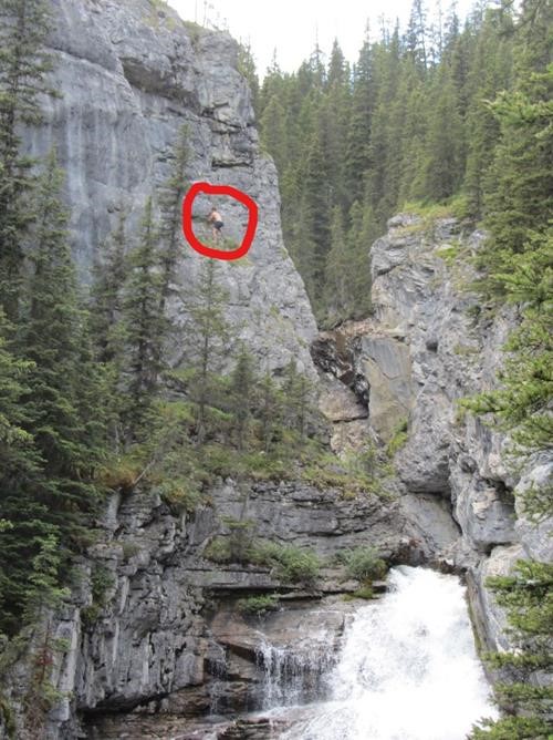 a brave barefoot climber (no climbing gear) above roaring North Ribbon Creek
