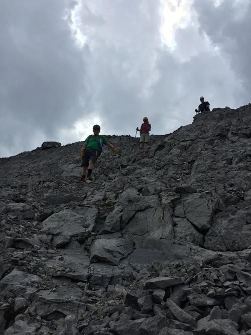 Descending scree as storm clouds build