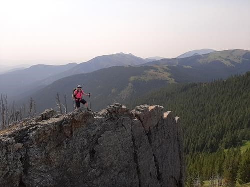 Jane on the rocks, Windy Peak in the distance.