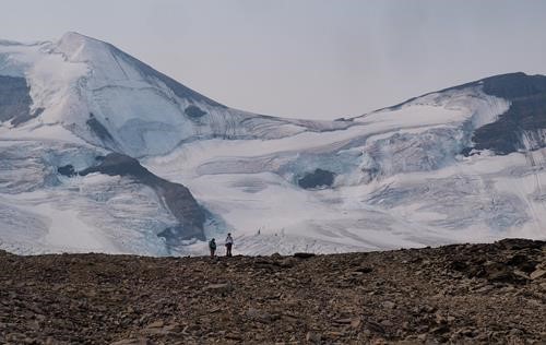 Jane and Jim waiting on a plateau in front of Athabasca Glacier.