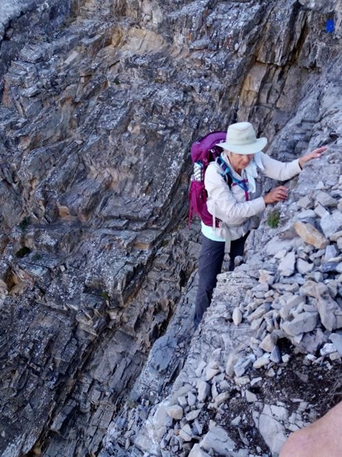 Jo Anne slowly traversing ledge at top of gully