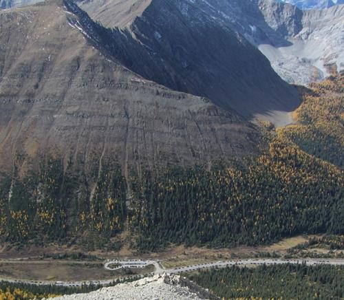 Looking down at the many cars in the Highwood Pass parking lot and along the highway