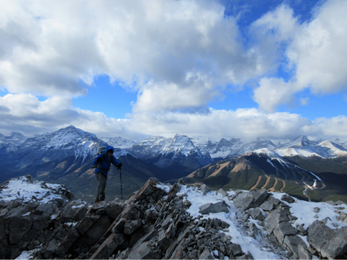 Barb traversing the ridge with Nakiska Ski Hill in the background