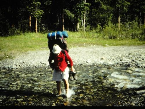 {0 Richard Jull} crosses a river while on a backpack near Sundrie, Alberta
