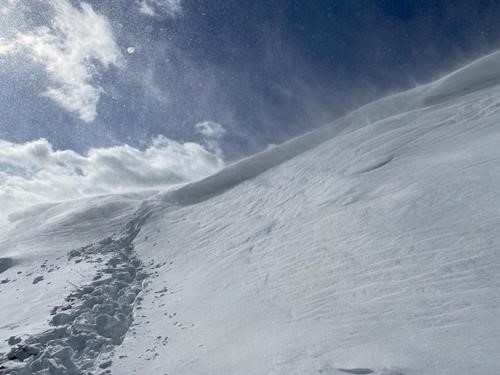 Dropping back down over the cornice to escape the wind
