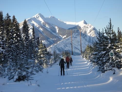 Skiing down Hydroline with Mts Indefatigable north and south in the distance